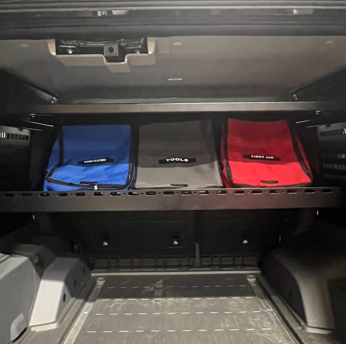 Upper Deck loaded with three color-coded bags over an empty cargo floor