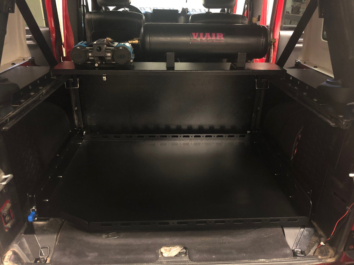 Empty JKU slide floor retracted under an onboard air tank shelf