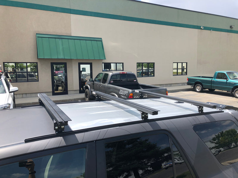 Eezi-Awn K9 load bars on a silver SUV roof