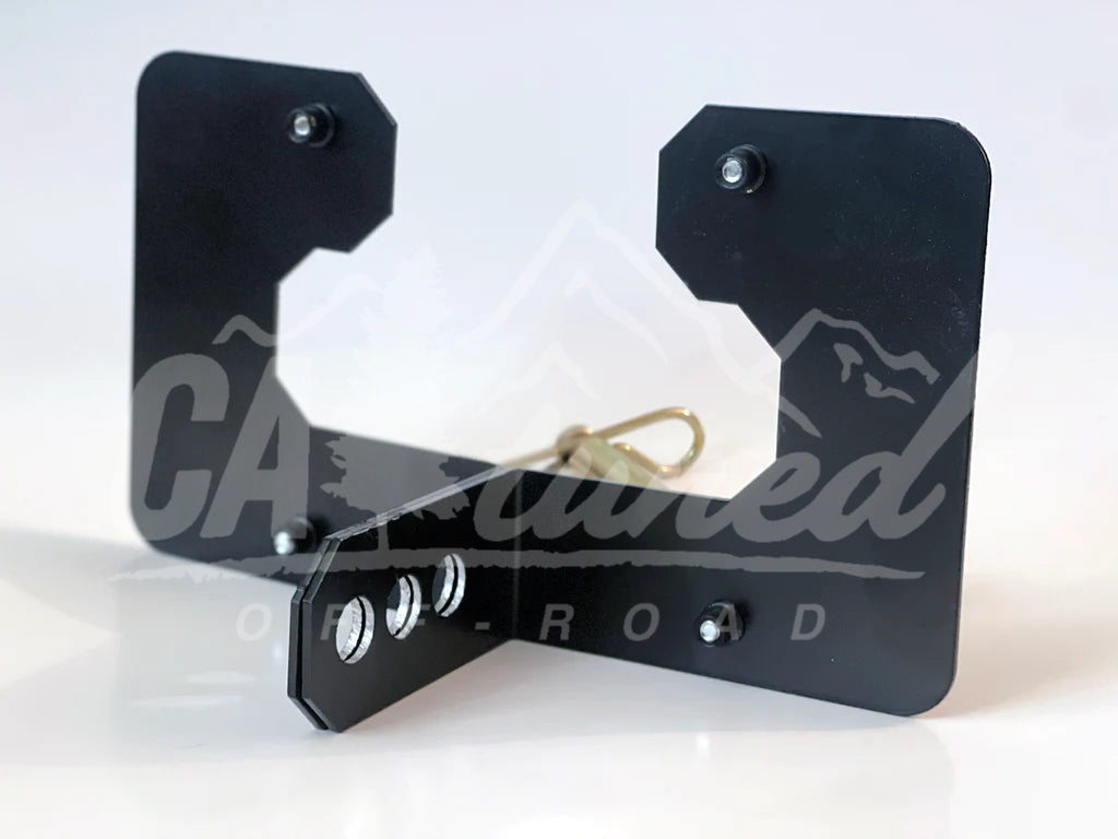 Back of the black plate bracket with the pin and clip beside it
