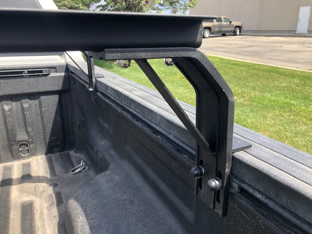 K9 bed rail mount leg and load bar in a truck bed, side view