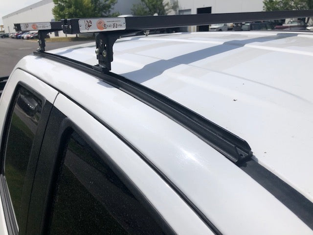 K9 load bar and mounting leg on a white vehicle roof