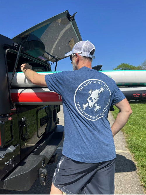 Man at a Jeep wearing the heathered blue T-shirt with the back logo