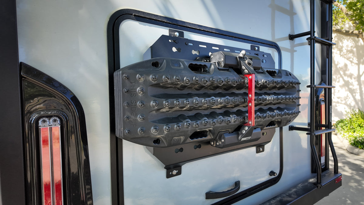 Recovery boards mounted on a MOLLE panel next to a tail light