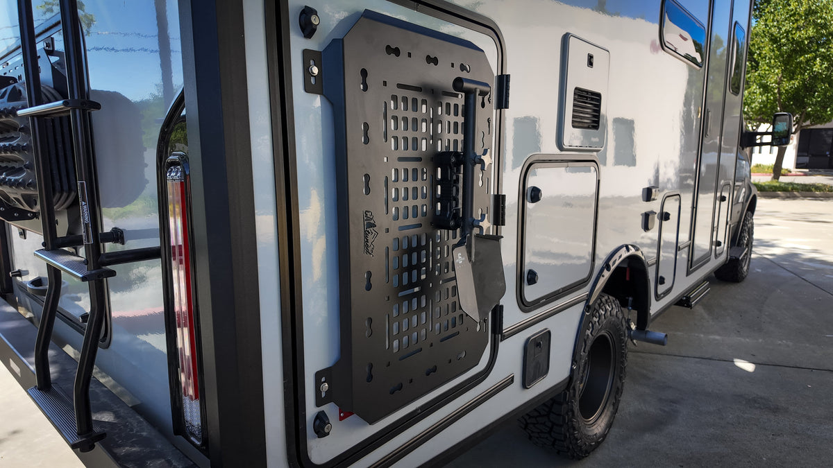 Black MOLLE panel on a van door with the side of the van behind
