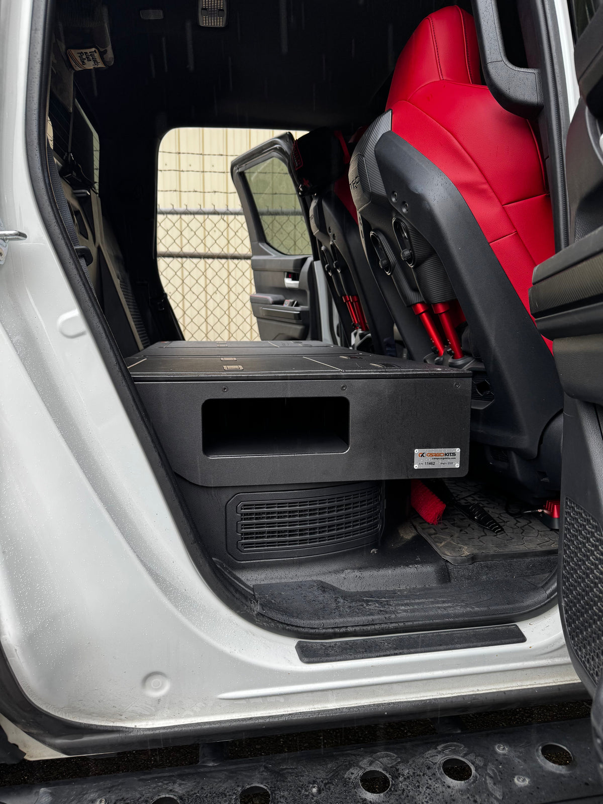 CargoKits Rear Seat Delete platform installed in a Tacoma TRD Pro Hybrid, head-on view showing both access hatches