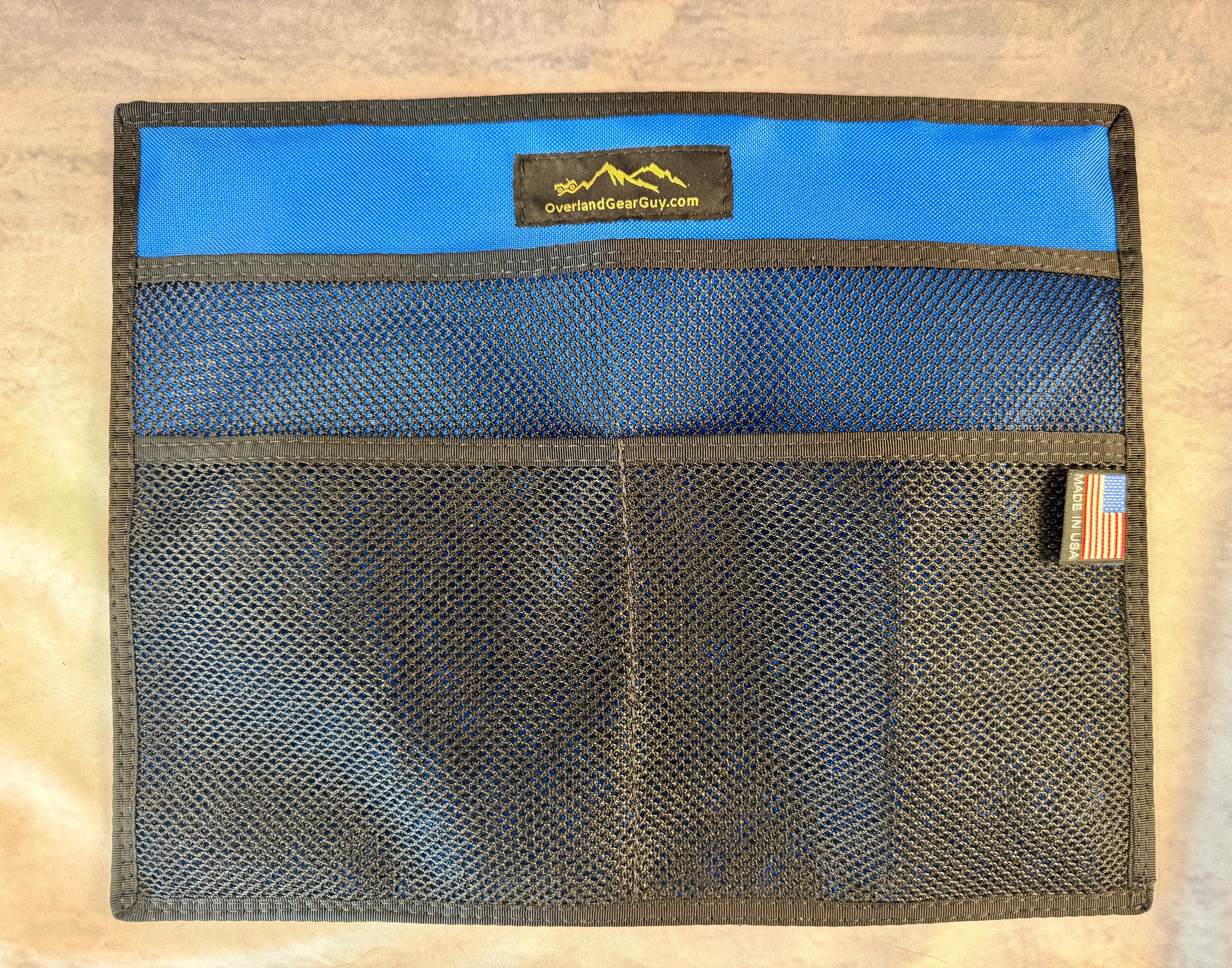 Pouch relocated to a steel cargo panel in the back of a vehicle