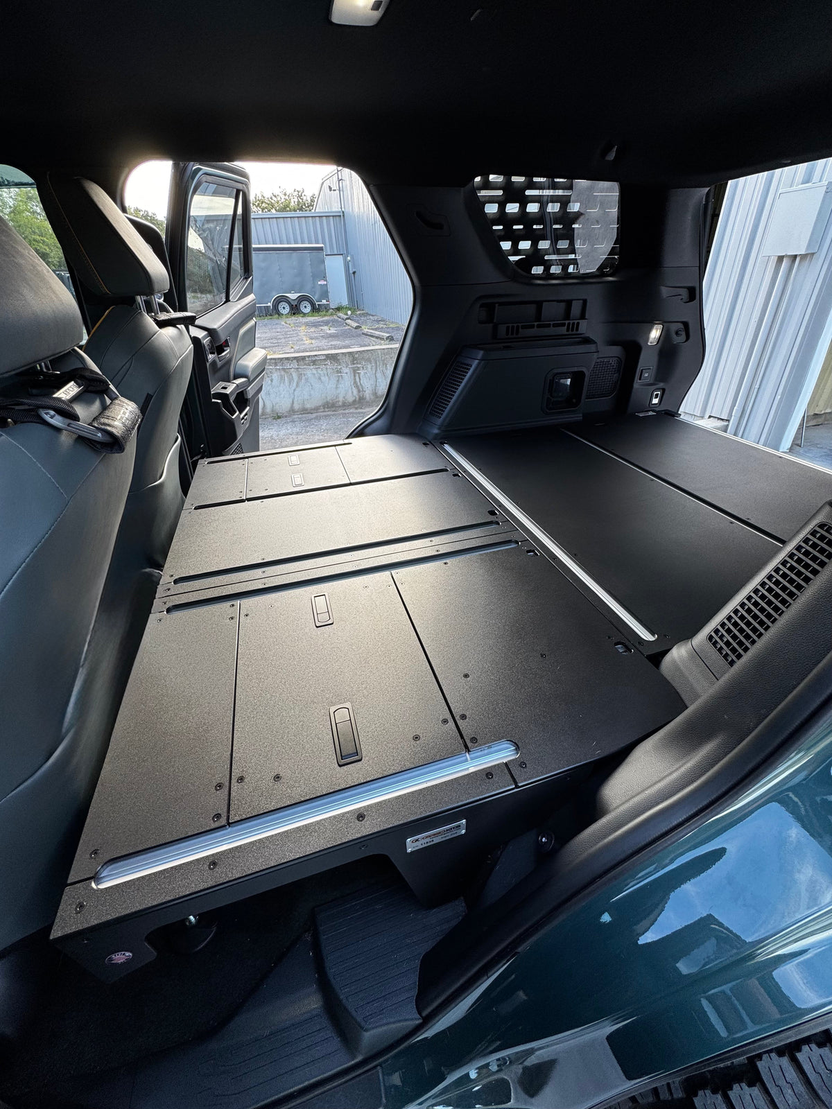 CargoKits Base Plate System in a 4Runner Hybrid, close-up of the extrusion track and mounting hardware