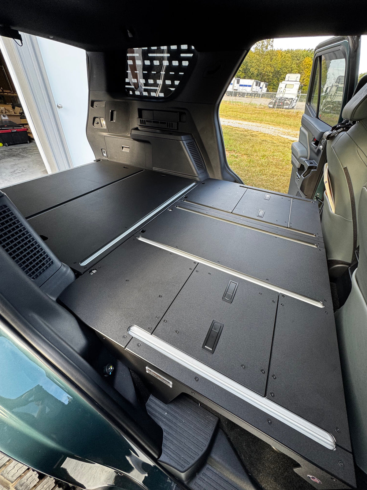CargoKits Base Plate System installed in a 4Runner Hybrid, view through the open rear door showing the flat load floor and drawer cabinet below