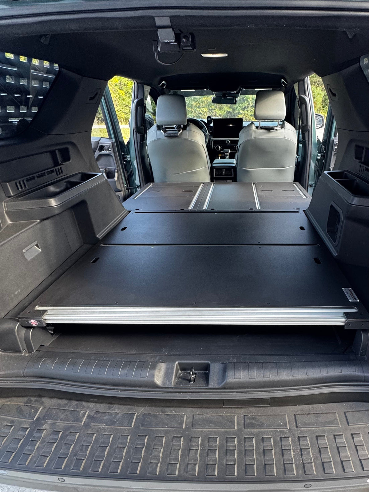 CargoKits Base Plate System in a 4Runner Hybrid, looking in from the open tailgate at the flat aluminum load floor