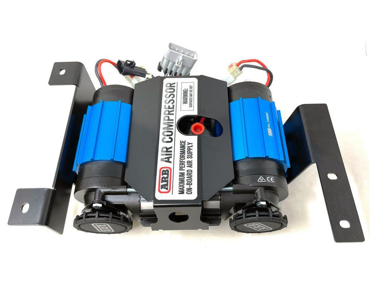Blue twin air compressor on its black mount, viewed from above