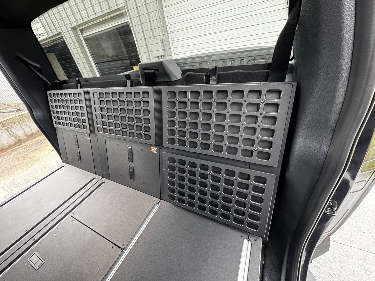 CargoKits Universal Molle Panel installed alongside the Rear Seat Delete platform, real install photo