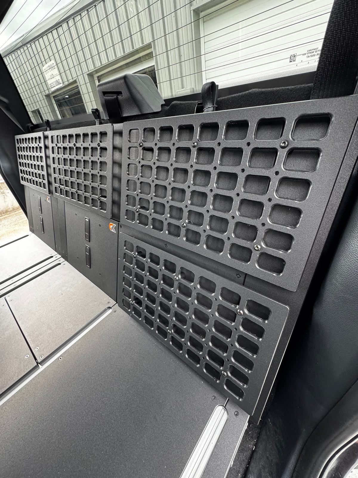 CargoKits Universal Molle Panel mounted on the side wall above a Rear Seat Delete platform, shown installed in a Ford F-Series SuperCrew