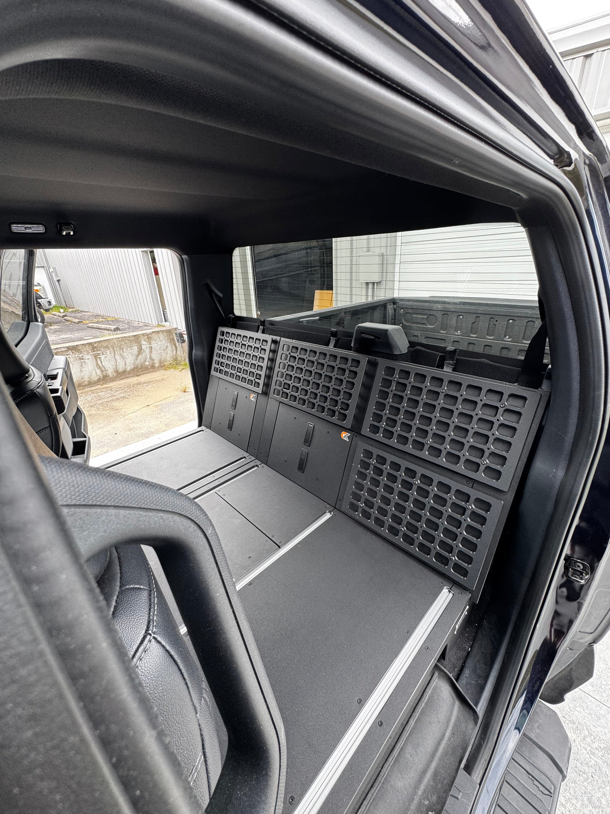 CargoKits MOLLE side wall panel close-up showing the grid of mounting slots in a Ford F-Series SuperCrew