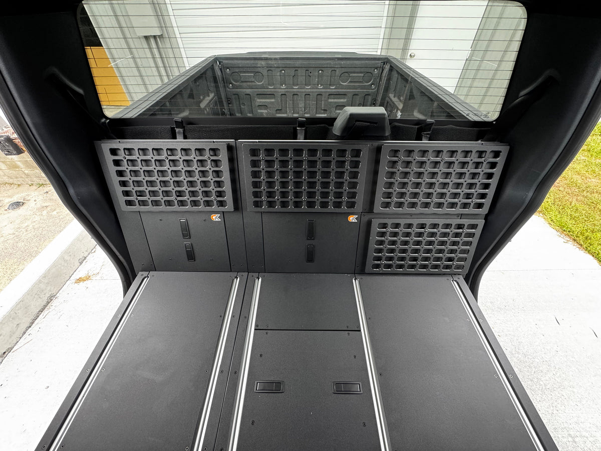 CargoKits MOLLE side wall panels and Rear Seat Delete platform in a Ford F-Series SuperCrew, view looking forward through the tailgate opening