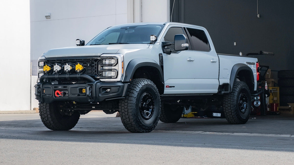 Lifted white 2023+ Ford Super Duty Tremor with aftermarket bumper, the truck the Mountain Hatch panel is photographed on