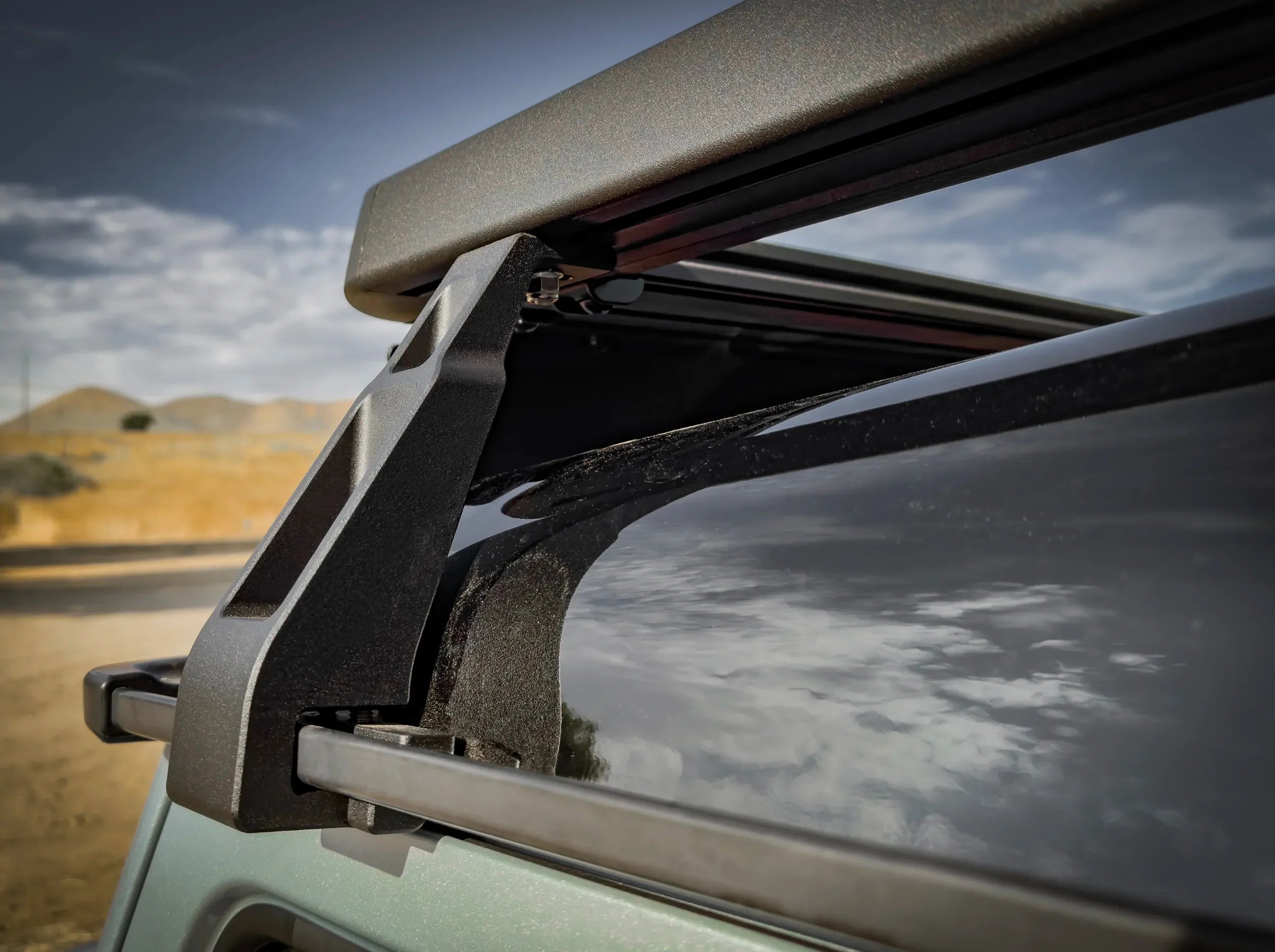 CLOSE UP VIEW OF INEOS GRENADIER FULL LENGTH ROOF RACK MOUNTING BRACKET