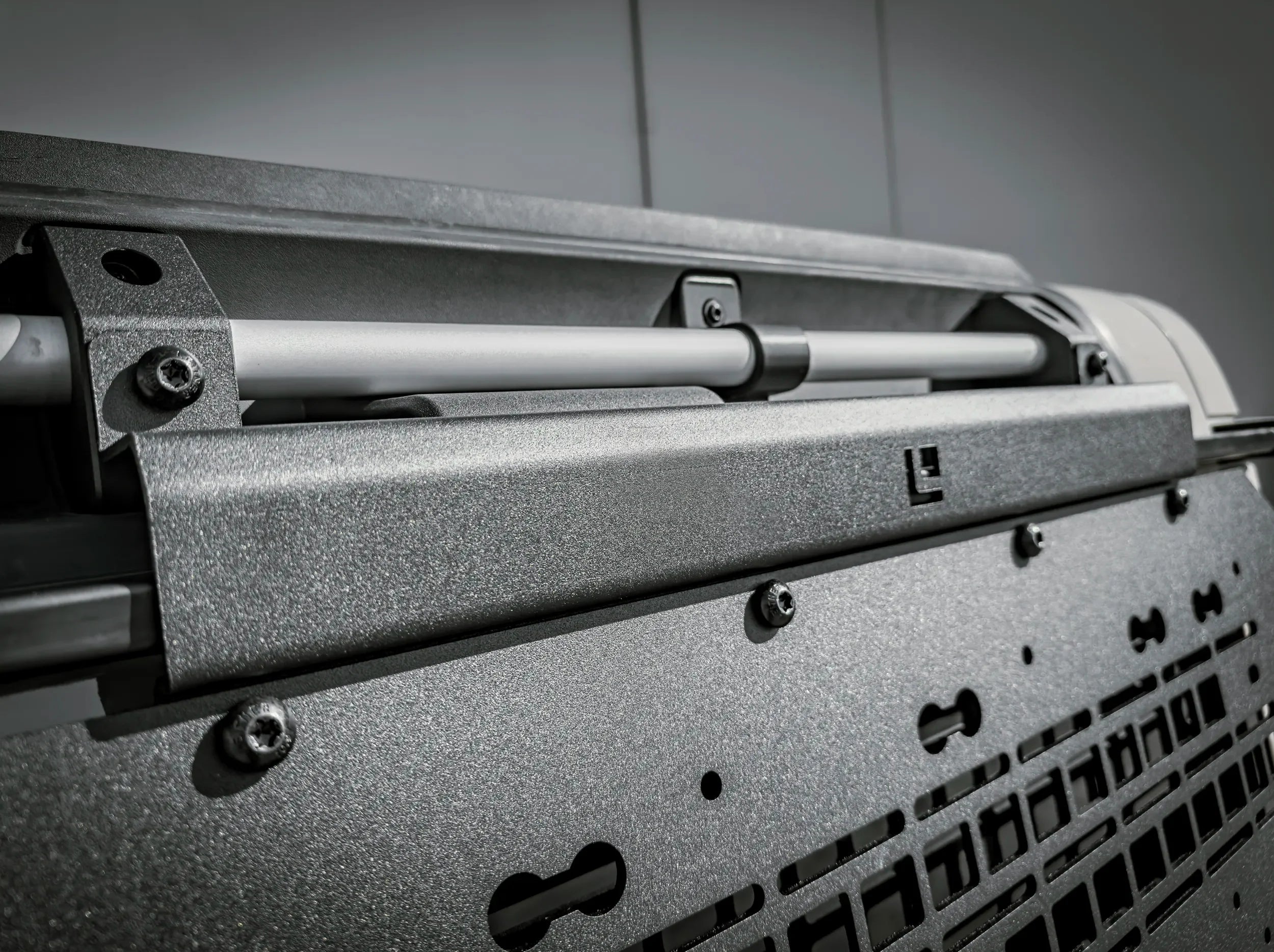 CLOSE UP VIEW OF INEOS GRENADIER UNIVERSAL SIDE KICK PANEL BRACKET INSTALLED