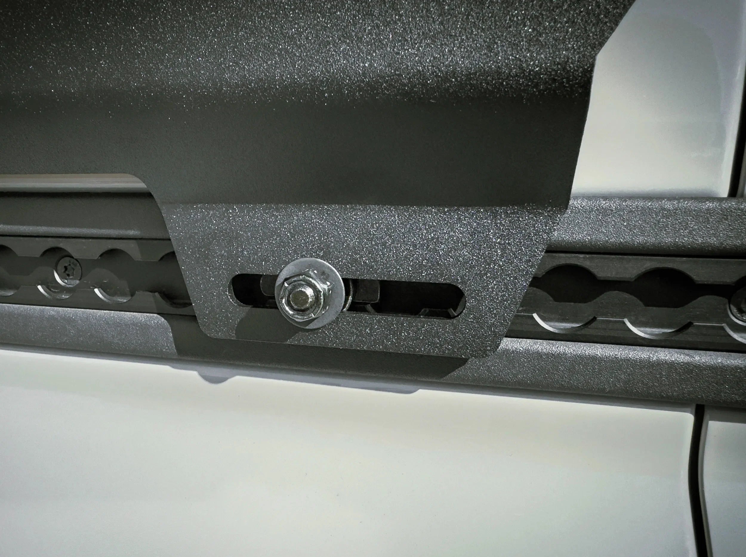 CLOSE UP VIEW OF INEOS GRENADIER UNIVERSAL SIDE KICK PANEL MOUNTED ON TOOL BELT L TRACK