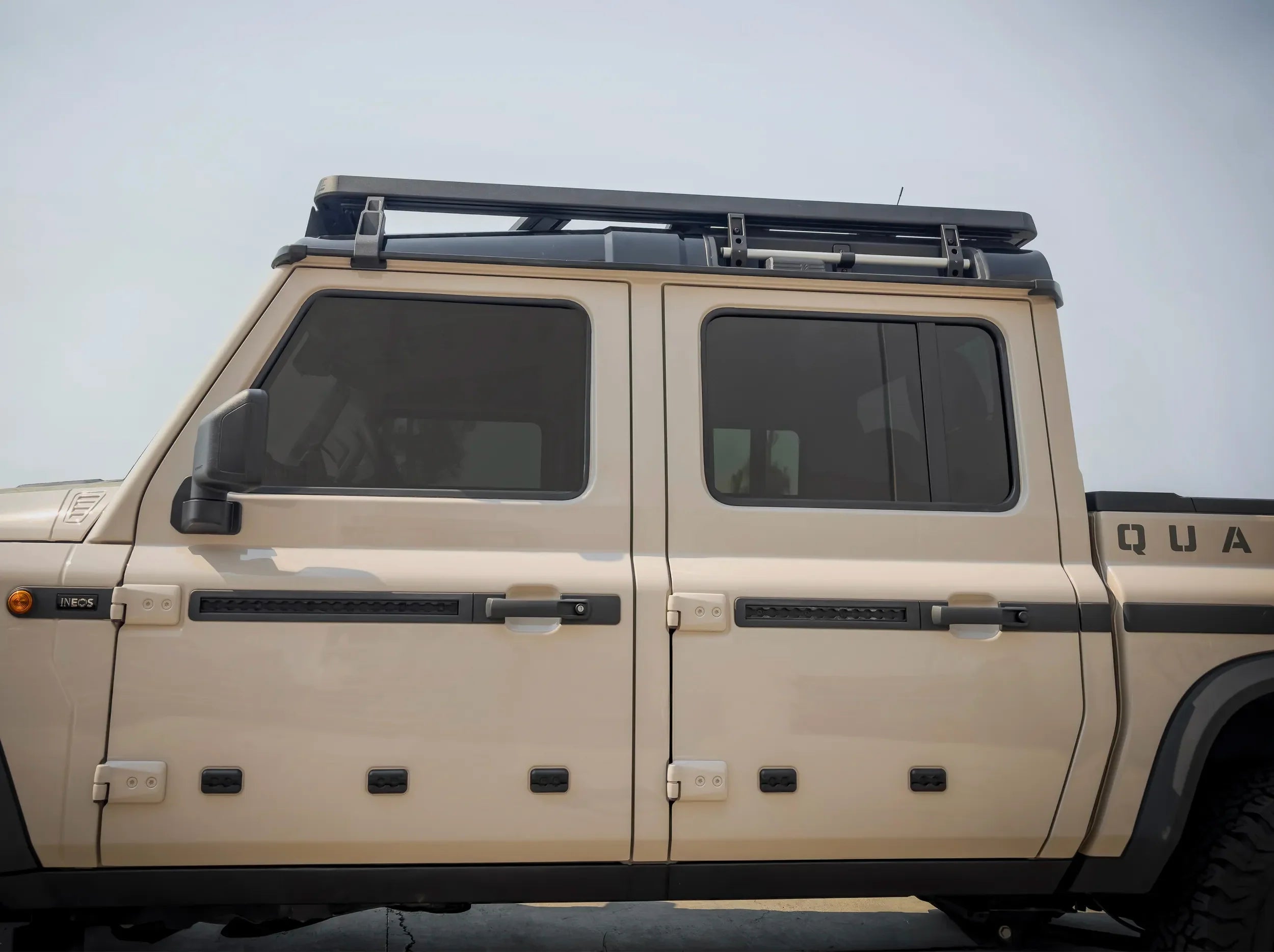 SIDE VIEW OF GRENADIER QUARTERMASTER WITH FULL LENGTH ACS ROOF RACK INSTALLED 