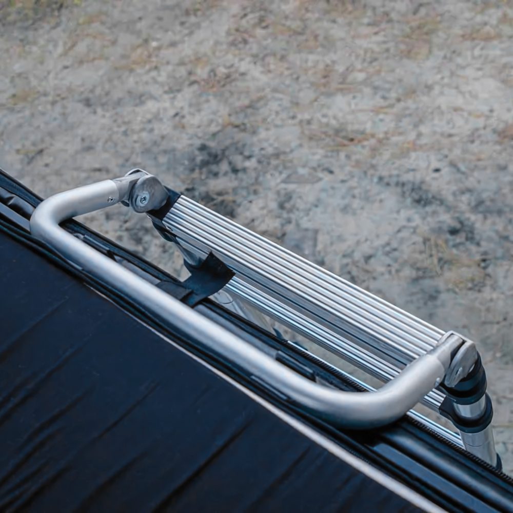 Hook-style ladder extension attached to the edge of a rooftop tent