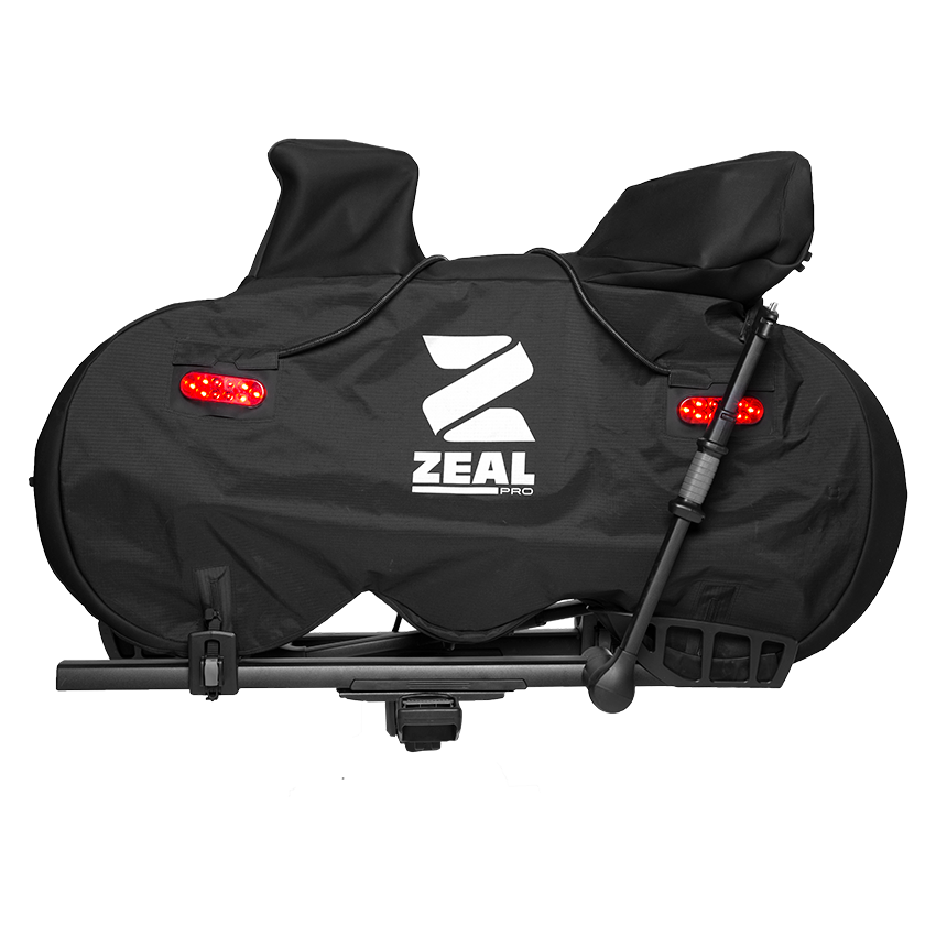 ZEAL Pro road bike cover on a tray hitch rack with Light Kit tail lights, on a black background