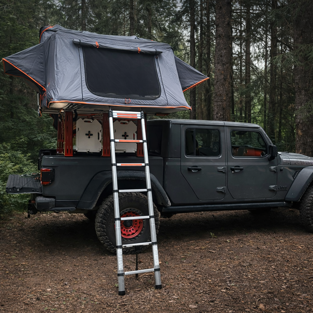 Gray Jeep Gladiator with HMOR ROCK-IT rack, open rooftop tent and ladder in the forest