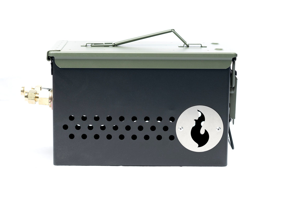 Olive green ammo-can-style firebox with perforated side vents and flame logo medallion, studio shot on white background