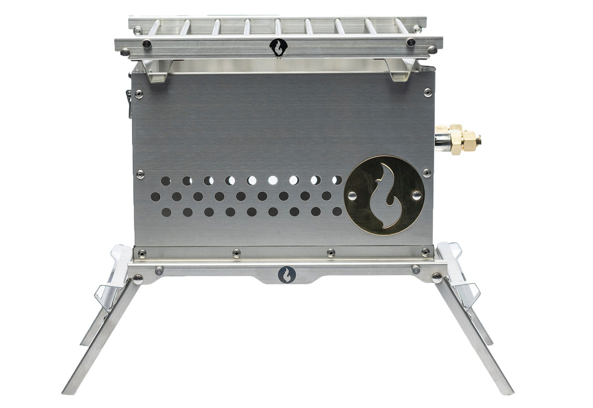 Stainless steel firebox with slotted grill grate on top and folding legs extended, studio shot on white background