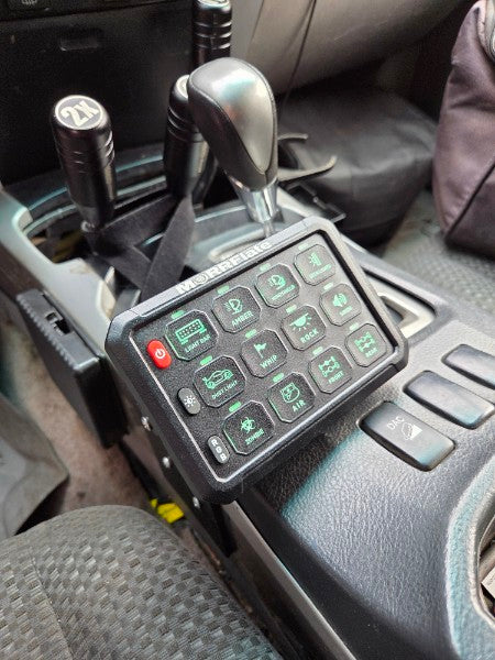 MORRFlate switch panel mounted on a vehicle center console beside the gear shifter