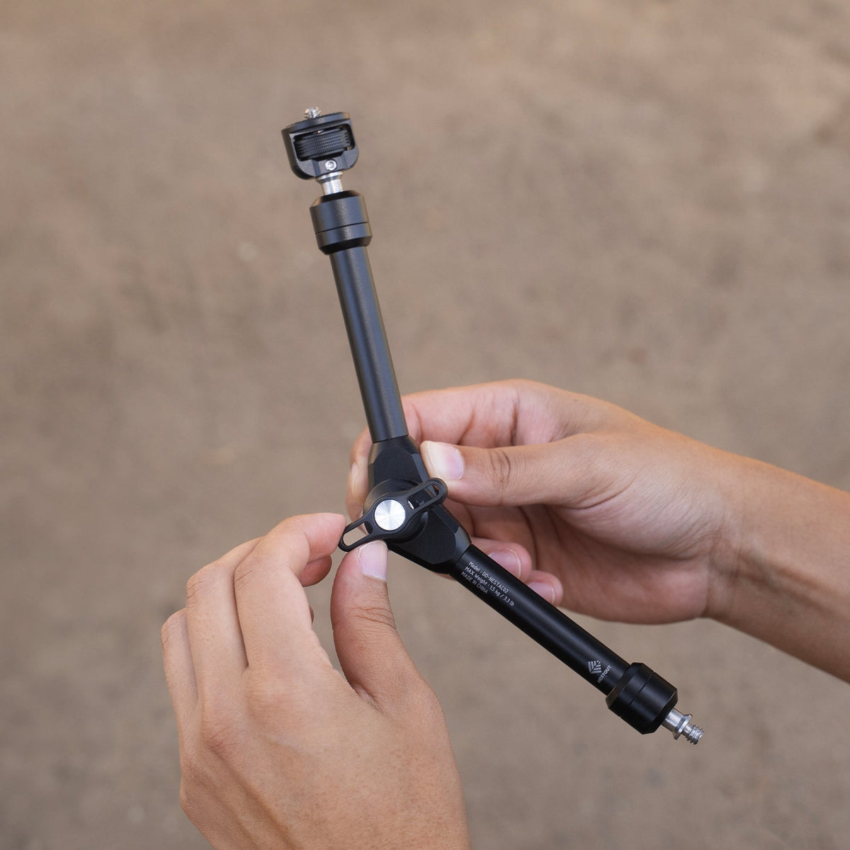 Adjusting the NESTOUT Clamp Arm's center locking knob, black colorway