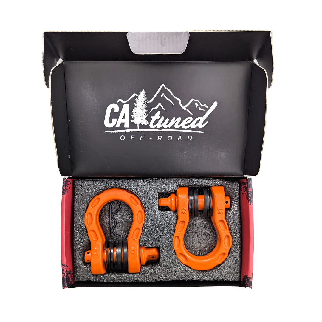 Open box holding a pair of orange D-ring shackles