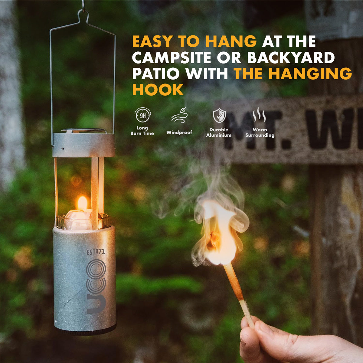 Brass UCO Candlelier candle lantern lit and hanging by its handle