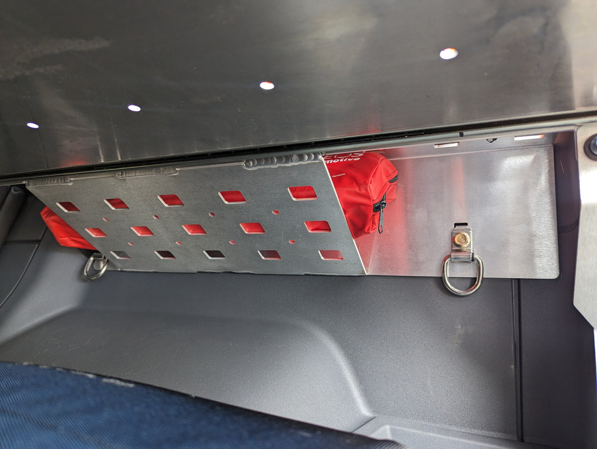 Perforated metal side panel with red accents mounted in the cargo area