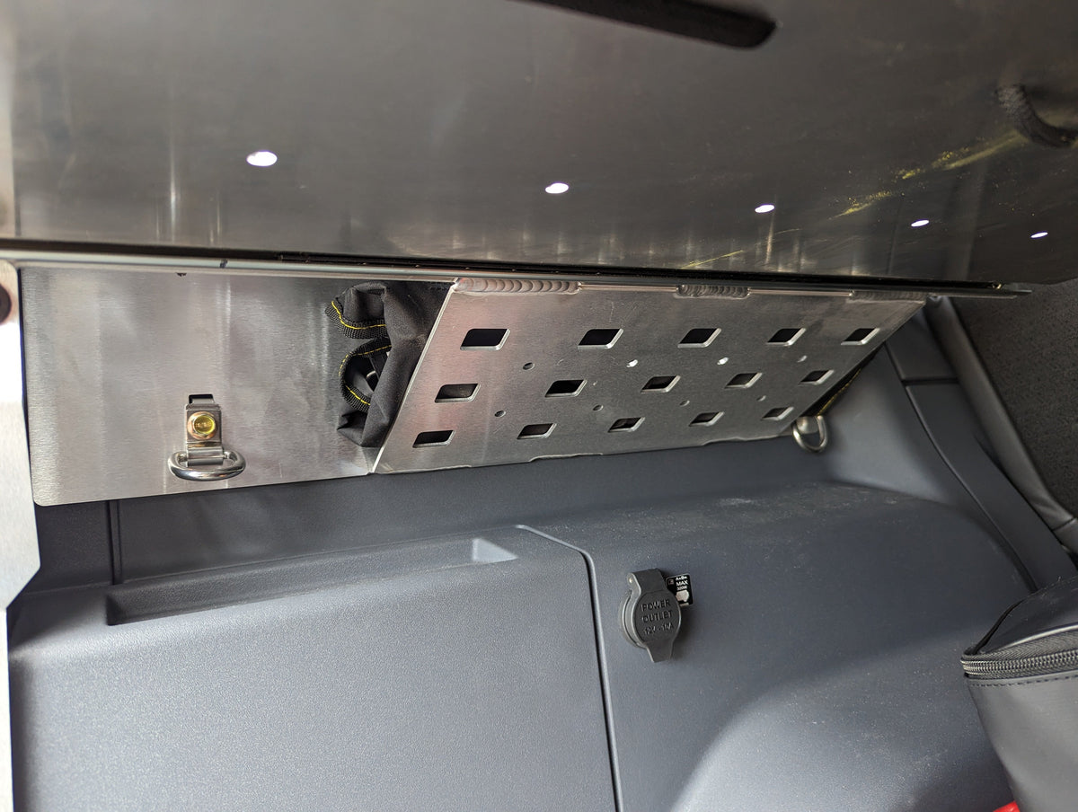 Metal panel with cutouts on the cargo area wall