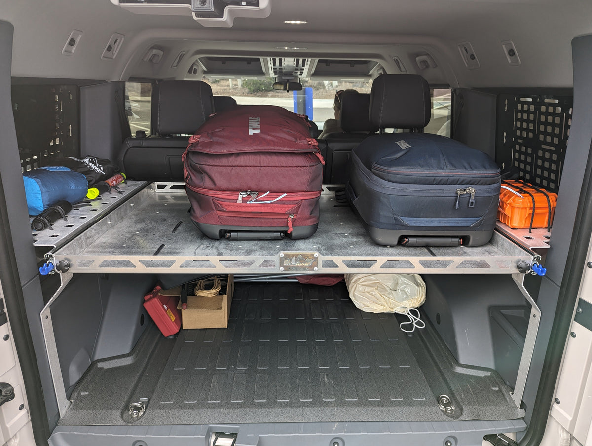 Cargo area with the shelf installed above two suitcases