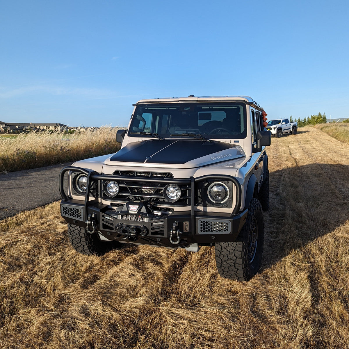Front view of an SUV with a bull bar parked on a dirt road
