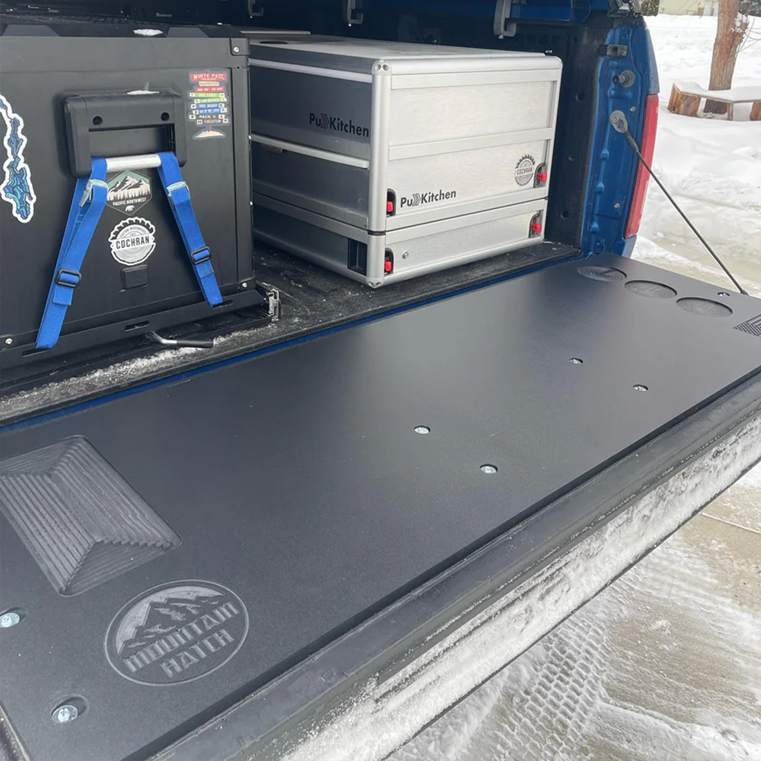 Mountain Hatch tailgate table on a 2019-2023 Ford Ranger tailgate with a Hi-Lift jack and camp kitchen boxes in the bed