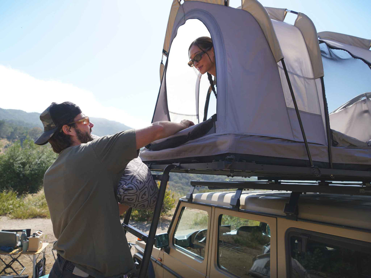 C6 Rev Rooftop Tent X (Eclipse) – person at the platform beside the tent
