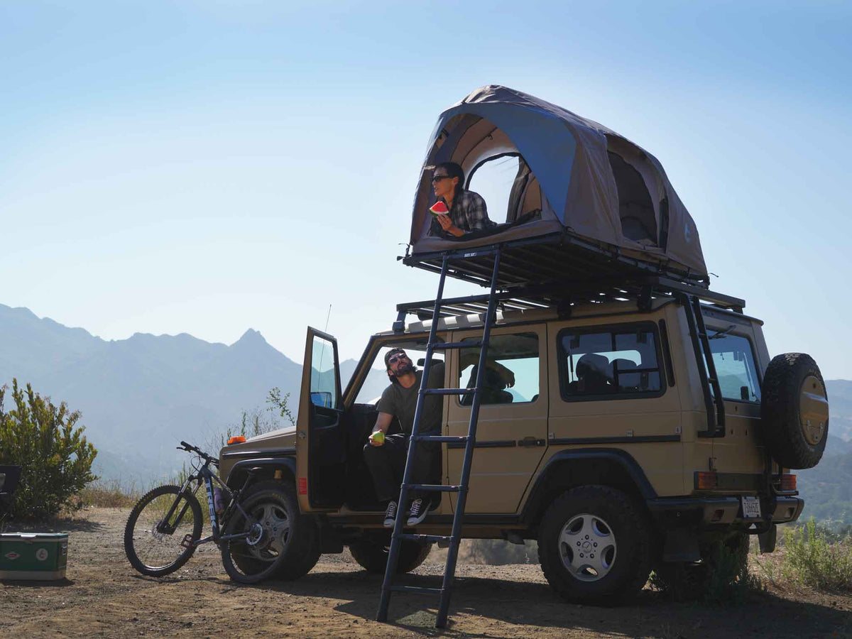 C6 Rev Rooftop Tent X (Element) – on a vehicle roof at camp with ladder deployed