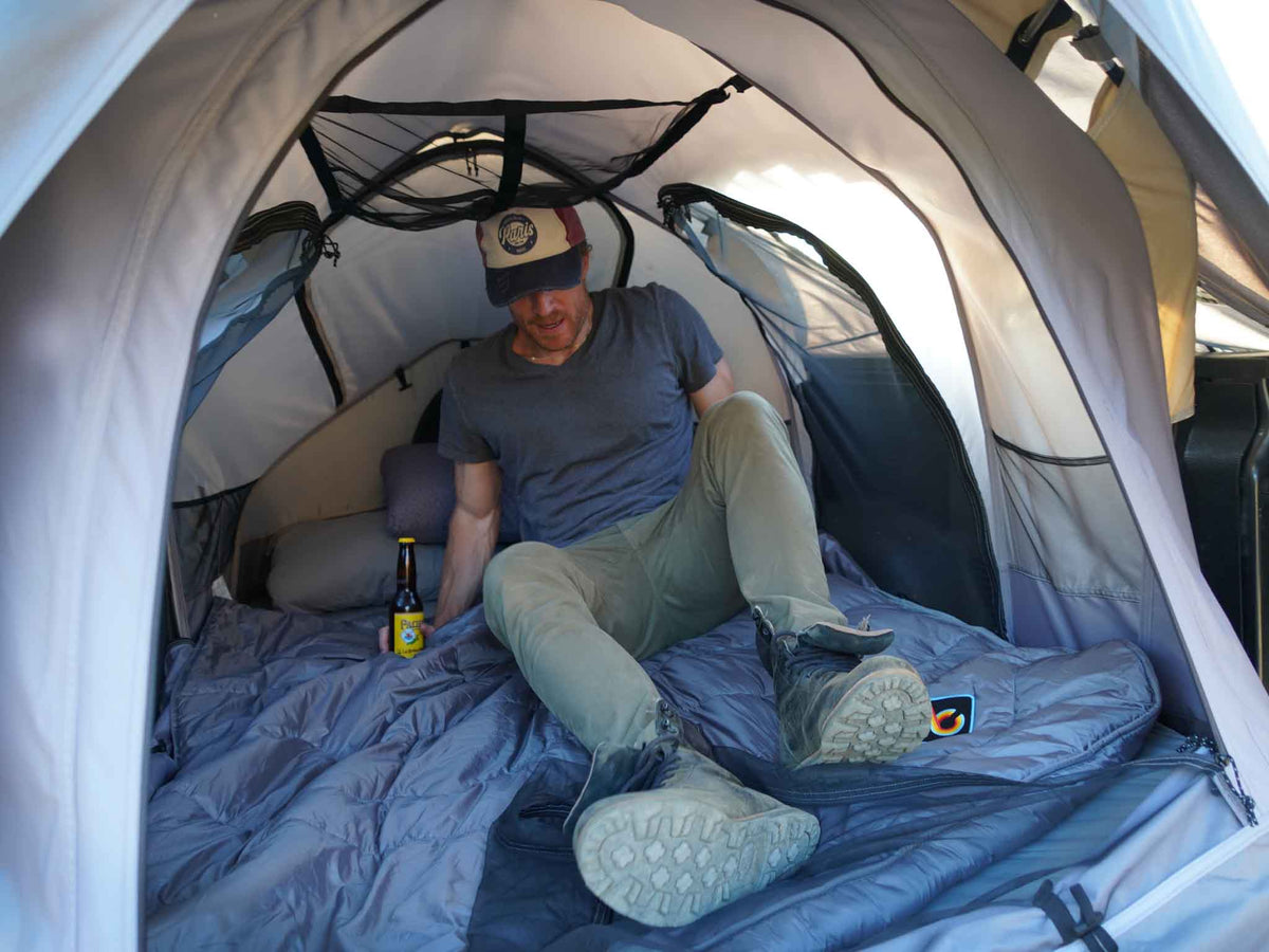 C6 Rev Pickup Truck Tent – person resting inside the tent