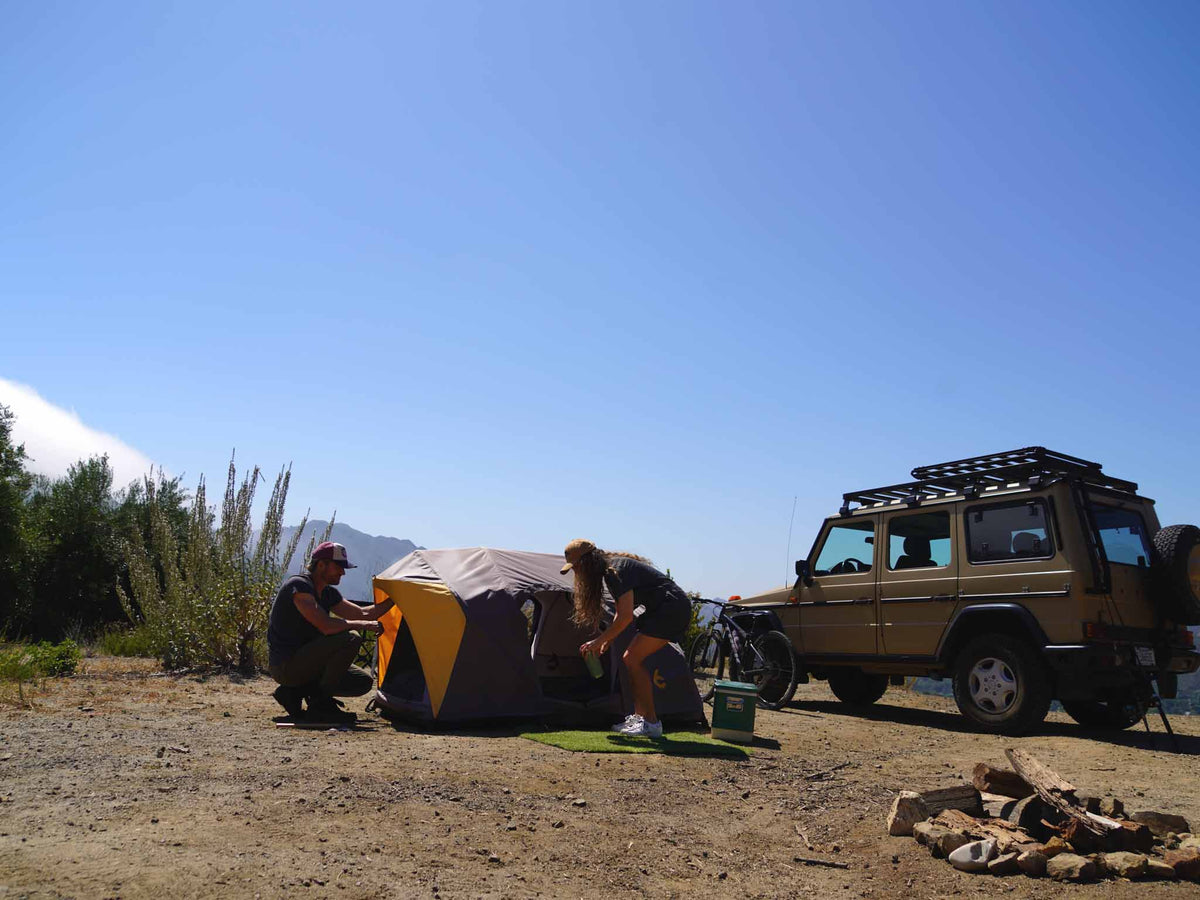 C6 Rev Rooftop Tent X (Element) – camp scene with a ground tent and vehicle