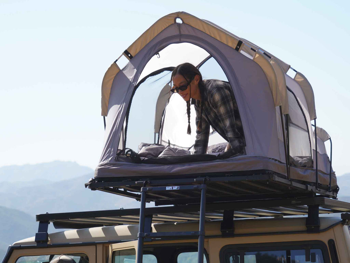 C6 Rev Rooftop Tent X (Eclipse) – person looking out of the tent on a roof platform