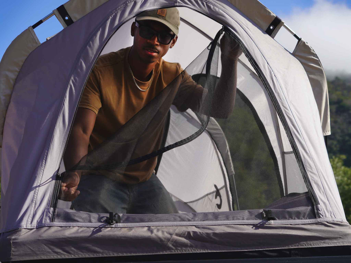 C6 Rev Rack Tent (HellaStorm) – person inside the open tent