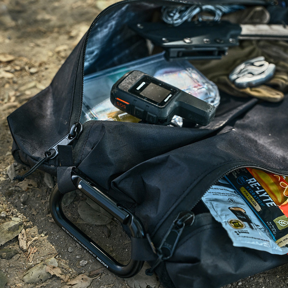 Close-up of the Colfax Equipment Module — UL's carabiner and end loop with a satellite communicator inside