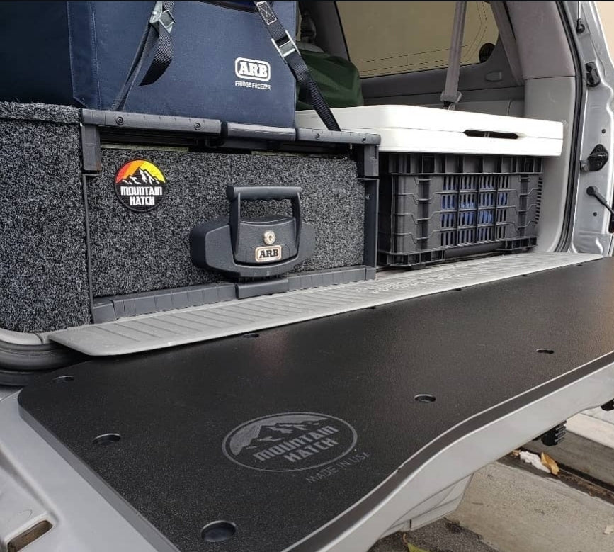 Mountain Hatch panel on an 80 Series Land Cruiser tailgate with an ARB fridge and drawer system in the cargo area