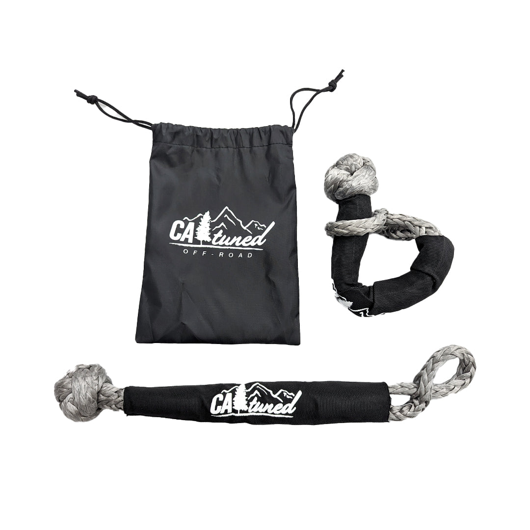 Two gray soft shackles beside a black storage pouch with a logo
