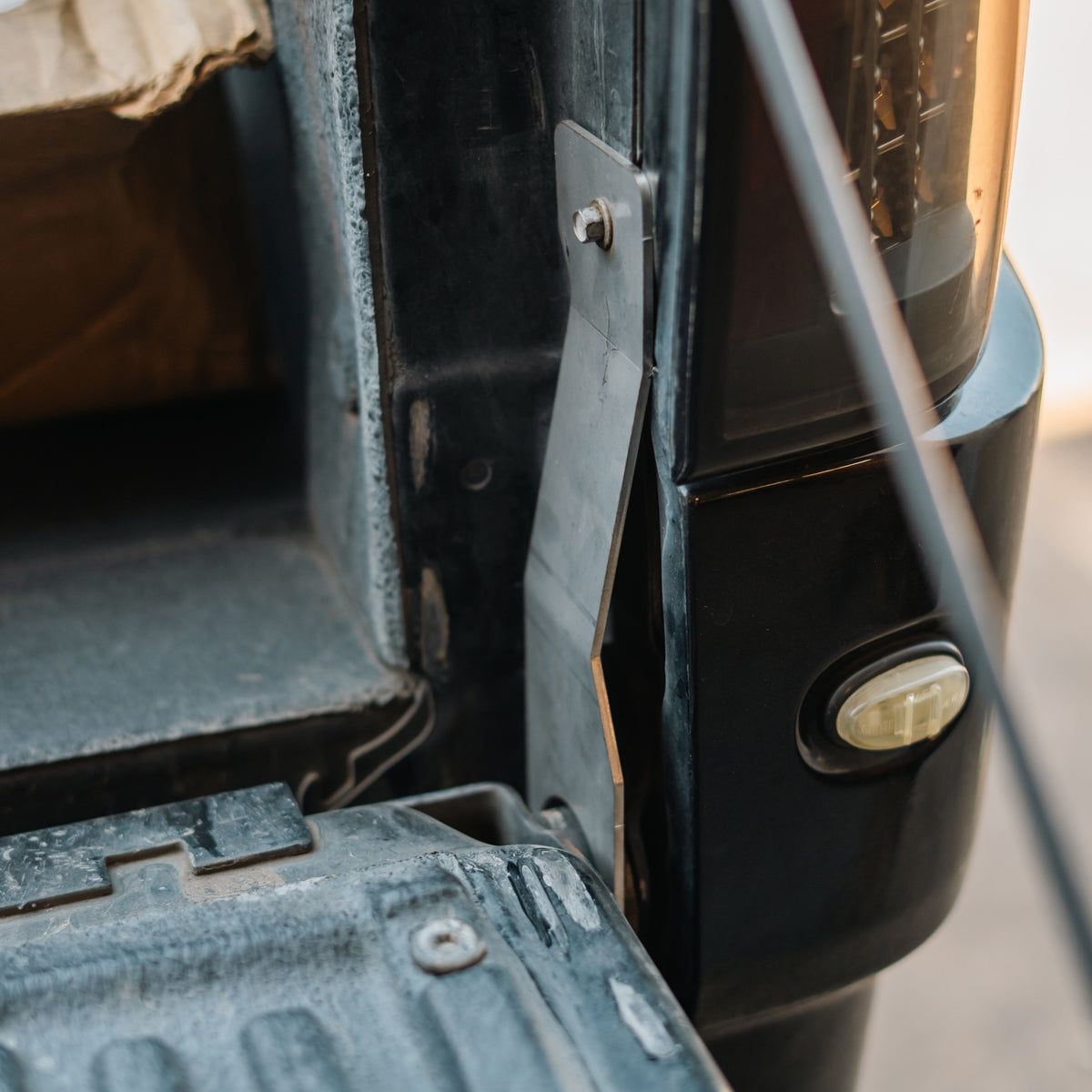 Cali Raised LED tailgate theft protector installed on a Ford F-150 tailgate, angled view near the truck bed