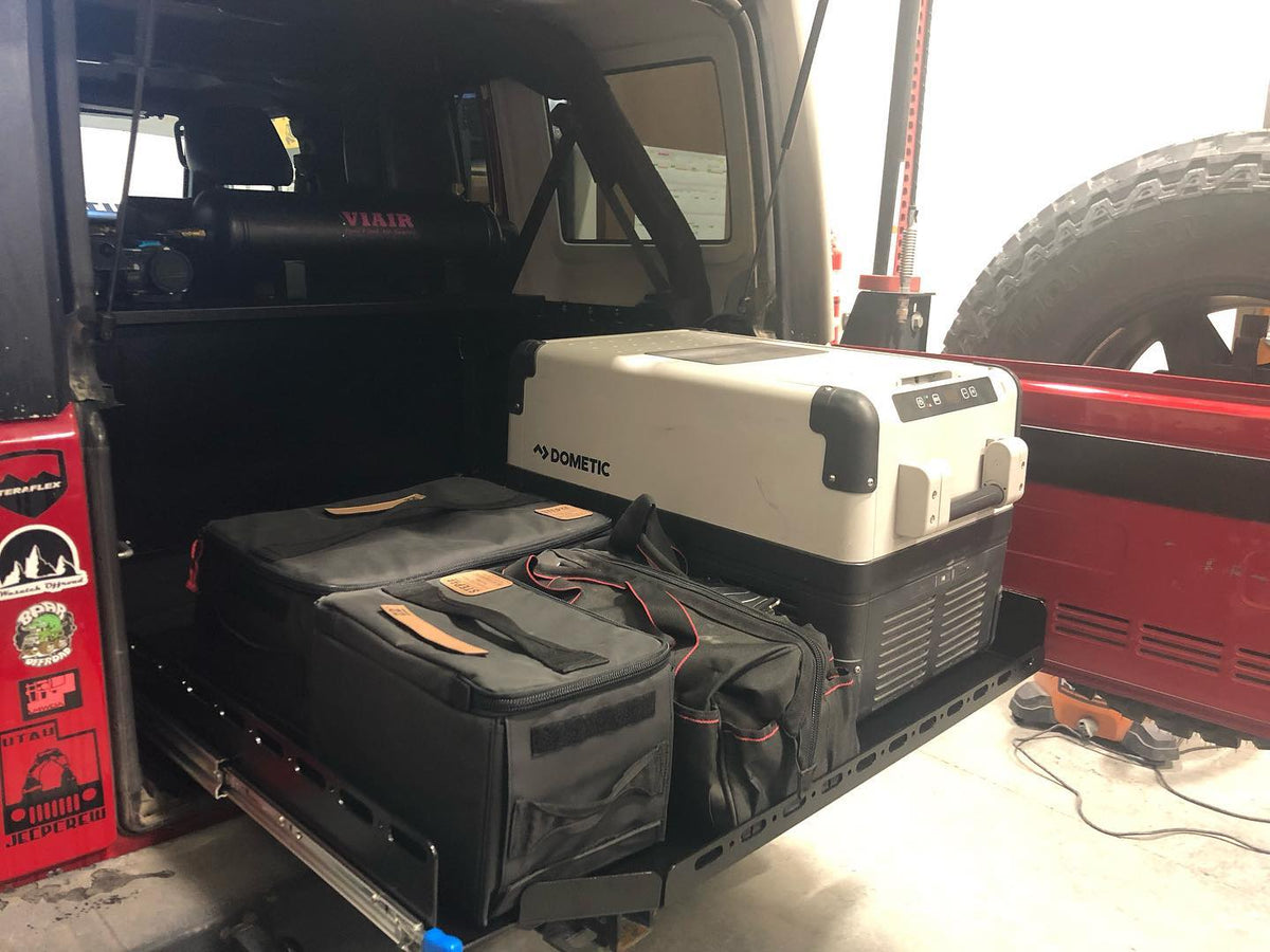 Slide floor extended with the fridge and gear bags pulled out to the tailgate