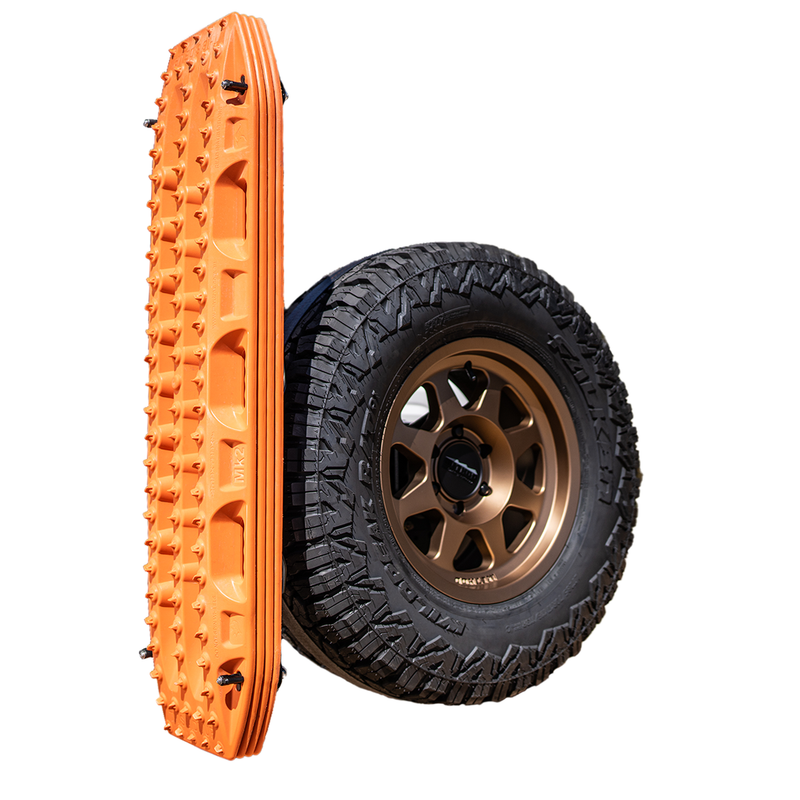 Orange Maxtrax MKII on the Overland Kitted Spare Tire Mount, attached to a tire